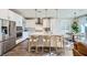 Bright kitchen features stainless appliances, an island with seating, and pendant lighting at 12532 Blissful Sky St, Las Vegas, NV 89138