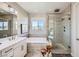 Spa-like main bathroom with soaking tub, glass shower, dual vanities, and modern fixtures at 12532 Blissful Sky St, Las Vegas, NV 89138