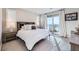 Serene bedroom with large bed, neutral decor, and sliding glass doors to a private balcony with scenic views at 12532 Blissful Sky St, Las Vegas, NV 89138