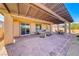 Inviting covered back patio with brick pavers and ample seating, perfect for outdoor entertaining at 1319 Yosemite St, Boulder City, NV 89005