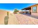 Backyard with brick pavers, desert landscaping, and an olive tree, perfect for outdoor relaxation at 1319 Yosemite St, Boulder City, NV 89005