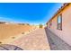 Long backyard featuring desert landscaping, a brick paver patio, and privacy walls at 1319 Yosemite St, Boulder City, NV 89005