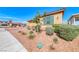 Well-maintained home featuring desert landscaping, a stylish exterior, and a welcoming curb appeal at 1319 Yosemite St, Boulder City, NV 89005