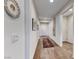 Inviting hallway featuring wood-look flooring, decorative wall art, and access to various rooms at 1319 Yosemite St, Boulder City, NV 89005