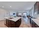 Open concept kitchen with large island, stainless steel appliances, and wood-look tile floors at 1319 Yosemite St, Boulder City, NV 89005