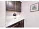 Functional laundry room with white quartz countertop, dark cabinets, and ample storage at 1319 Yosemite St, Boulder City, NV 89005