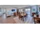 Open-concept living room and dining area with wood-look flooring and sliding glass doors to the patio at 1319 Yosemite St, Boulder City, NV 89005