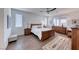Relaxing main bedroom with wood-look tile, ceiling fan, and bright natural light at 1319 Yosemite St, Boulder City, NV 89005