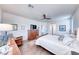 Light, bright main bedroom featuring wood-look tile, ceiling fan, and relaxing furnishings at 1319 Yosemite St, Boulder City, NV 89005