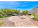 Scenic park area featuring a brick walkway, benches, trees, and lush landscaping at 1319 Yosemite St, Boulder City, NV 89005