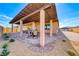 Covered patio with pavers offers ample seating and overlooks the backyard at 1319 Yosemite St, Boulder City, NV 89005