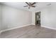 Spacious bedroom with wood-look flooring leading into the bathroom at 1400 Jamielinn Ln # 104, Las Vegas, NV 89110