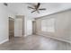 Bedroom with wood-look floors, ceiling fan, closet, and a bright window at 1400 Jamielinn Ln # 104, Las Vegas, NV 89110