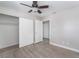 Bedroom with wood-look flooring, ceiling fan, closet with sliding doors, and a connecting doorway at 1400 Jamielinn Ln # 104, Las Vegas, NV 89110