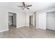 Spacious bedroom with wood-look floors, ceiling fan, and connecting bathroom at 1400 Jamielinn Ln # 104, Las Vegas, NV 89110