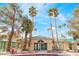Charming community clubhouse with palm trees, green tile roof, gated entrance, and well-maintained landscaping at 1400 Jamielinn Ln # 104, Las Vegas, NV 89110
