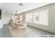 Staged dining room featuring modern furniture, large windows, and neutral decor at 1400 Jamielinn Ln # 104, Las Vegas, NV 89110