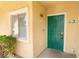 A green security door with decorative ironwork and a window next to apartment number 104 at 1400 Jamielinn Ln # 104, Las Vegas, NV 89110
