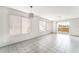 Bright, open-concept living room with tile floors, large windows, and access to a private balcony at 1400 Jamielinn Ln # 104, Las Vegas, NV 89110