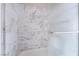 Up close view of a tub-shower combo with marbled tiling and clear glass door at 1400 Jamielinn Ln # 104, Las Vegas, NV 89110