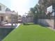 A spacious backyard including synthetic grass and play equipment at 1508 Silver Knoll Ave, Las Vegas, NV 89123