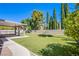 Expansive artificial grass backyard with a covered patio and play structure at 1508 Silver Knoll Ave, Las Vegas, NV 89123
