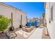 Backyard with block walls, a stone fire pit and a walkway on a sunny day at 1508 Silver Knoll Ave, Las Vegas, NV 89123
