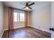 Bedroom featuring wood floors, pink curtains, and natural light at 1508 Silver Knoll Ave, Las Vegas, NV 89123