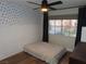 Cozy bedroom with wood floors, polka-dot accent wall, and natural light from a sunny window at 1508 Silver Knoll Ave, Las Vegas, NV 89123