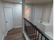 Bright hallway with wood floors, white walls, and black railings provides a clean and modern aesthetic at 1508 Silver Knoll Ave, Las Vegas, NV 89123