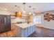 Modern kitchen with center island, stainless steel appliances, and decorative shelving at 1508 Silver Knoll Ave, Las Vegas, NV 89123