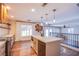 Kitchen with island, modern lighting fixtures, and a view to the backyard at 1508 Silver Knoll Ave, Las Vegas, NV 89123
