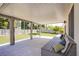 Covered patio with a seating area, overlooking an artificial grass yard at 1508 Silver Knoll Ave, Las Vegas, NV 89123