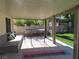 View of the covered patio, play equipment, and synthetic backyard lawn at 1508 Silver Knoll Ave, Las Vegas, NV 89123