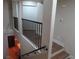 Staircase featuring wood steps, black railings, and abundant natural light coming in from nearby windows at 1508 Silver Knoll Ave, Las Vegas, NV 89123