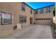 Large concrete backyard with neutral stucco walls and a multi-car garage perfect for outdoor entertaining at 165 Calm Morning Ave, Henderson, NV 89002