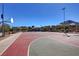 Community basketball court surrounded by a fence with residential buildings in the distance at 165 Calm Morning Ave, Henderson, NV 89002