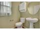 Well-lit bathroom with a pedestal sink and updated fixtures at 165 Calm Morning Ave, Henderson, NV 89002