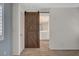 Bedroom with view into bathroom and featuring rustic barn door and carpet at 165 Calm Morning Ave, Henderson, NV 89002