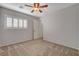 Bedroom featuring carpet, ceiling fan, and plantation shutters on a sunny day at 165 Calm Morning Ave, Henderson, NV 89002