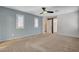 Spacious bedroom with carpeting, ceiling fan, and abundant natural light from windows with shutters at 165 Calm Morning Ave, Henderson, NV 89002