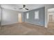 Bedroom with neutral carpet, ceiling fan, and large windows with shutters at 165 Calm Morning Ave, Henderson, NV 89002