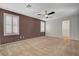 This large bedroom features carpet floors, two windows with white shutters and a ceiling fan at 165 Calm Morning Ave, Henderson, NV 89002