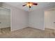 Spacious bedroom with a ceiling fan and entrances to a walk-in closet and bathroom at 165 Calm Morning Ave, Henderson, NV 89002