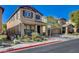 Inviting two-story home with a covered porch, manicured landscaping, and a multi-car garage with extended driveway at 165 Calm Morning Ave, Henderson, NV 89002