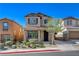 Charming two-story home featuring a well-manicured front yard and covered entry at 165 Calm Morning Ave, Henderson, NV 89002