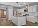 Bright kitchen features white cabinets, stainless steel appliances, and an island with a sink for convenient food prep at 165 Calm Morning Ave, Henderson, NV 89002