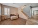 Cozy living room features wood floors, shuttered windows, and a staircase to the upper level of the home at 165 Calm Morning Ave, Henderson, NV 89002