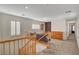 Loft space with carpet, wood railing, and a custom wood cabinet at 165 Calm Morning Ave, Henderson, NV 89002