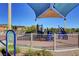 Outdoor playground with play structures and sunshade to protect children from the sun at 165 Calm Morning Ave, Henderson, NV 89002